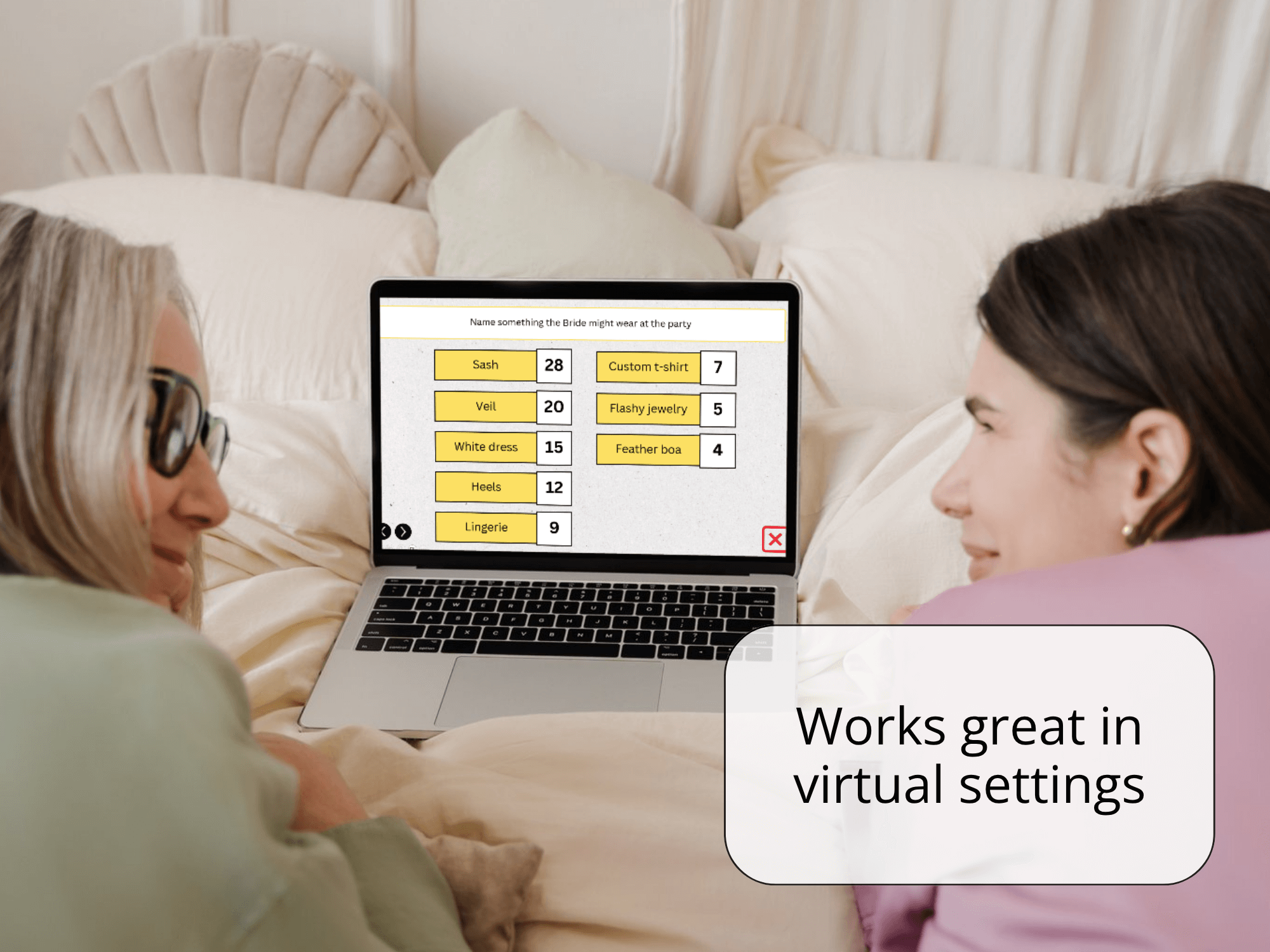 Two people sitting on a bed using a laptop with a virtual setting interface.