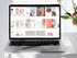 Laptop displaying a magazine layout on a white surface with a plant