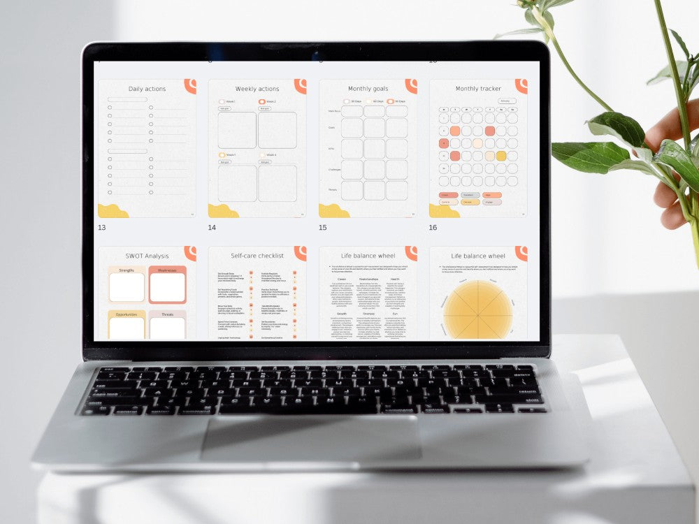 Laptop displaying a digital calendar on a white surface with a plant in the background