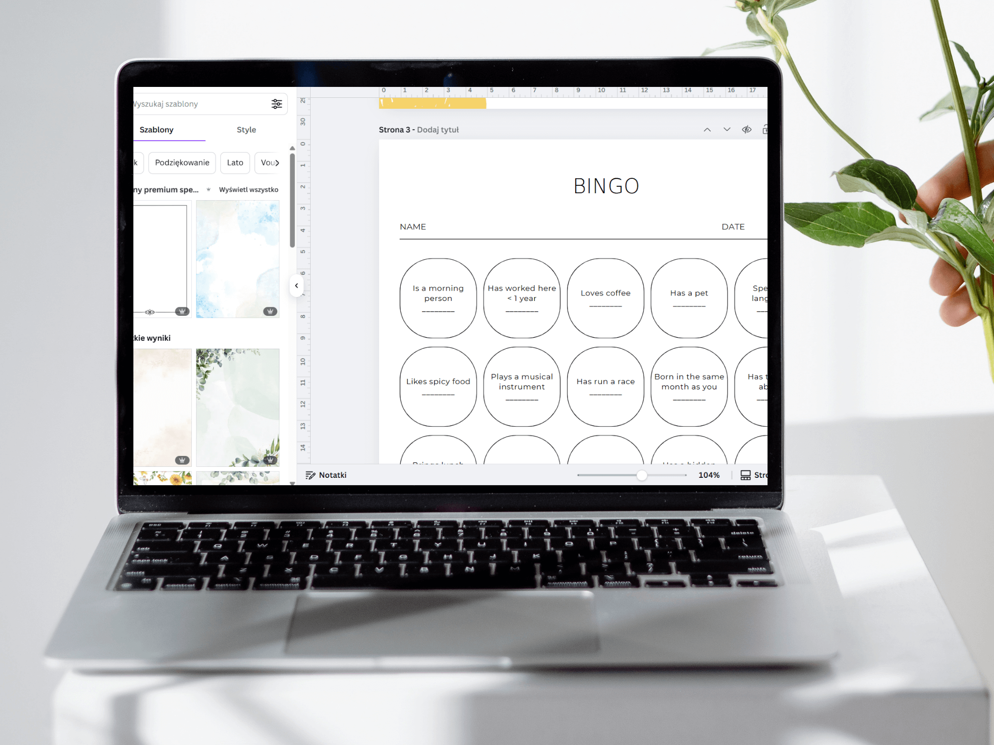 Laptop displaying a digital bingo game on a white surface with a plant in the background