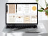 Laptop displaying a digital product on a white surface with a plant