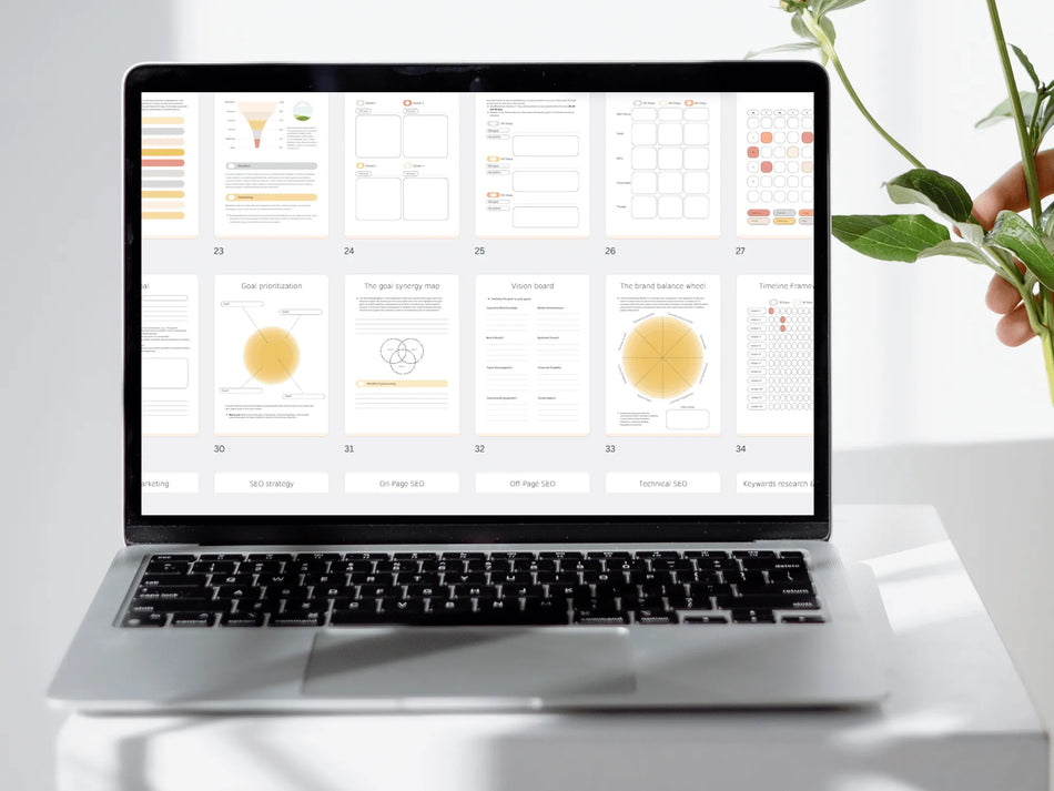 Laptop displaying a software interface on a white surface with a plant in the background