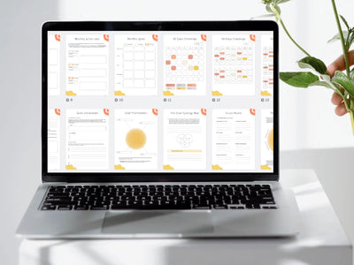 Laptop displaying a calendar app on a white surface with a plant in the background
