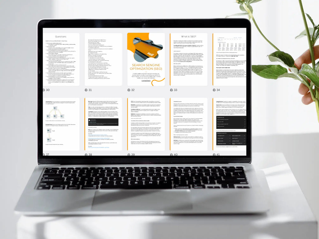 Laptop displaying a document on a white surface with a plant in the background