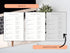 Open house sign-in sheets displayed on a desk with a laptop and plant.