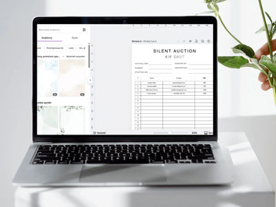 Laptop displaying a travel packing list on a white surface with a plant.