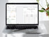 Laptop displaying a travel packing list on a white surface with a plant.