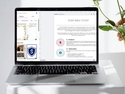 Laptop displaying a SOAP Bible Study interface on a white surface with a plant.