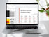 Laptop displaying a Russian language learning website on a white surface with a plant.