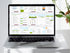 A laptop screen displaying a grid of many colorful business plan pages being edited in a design software