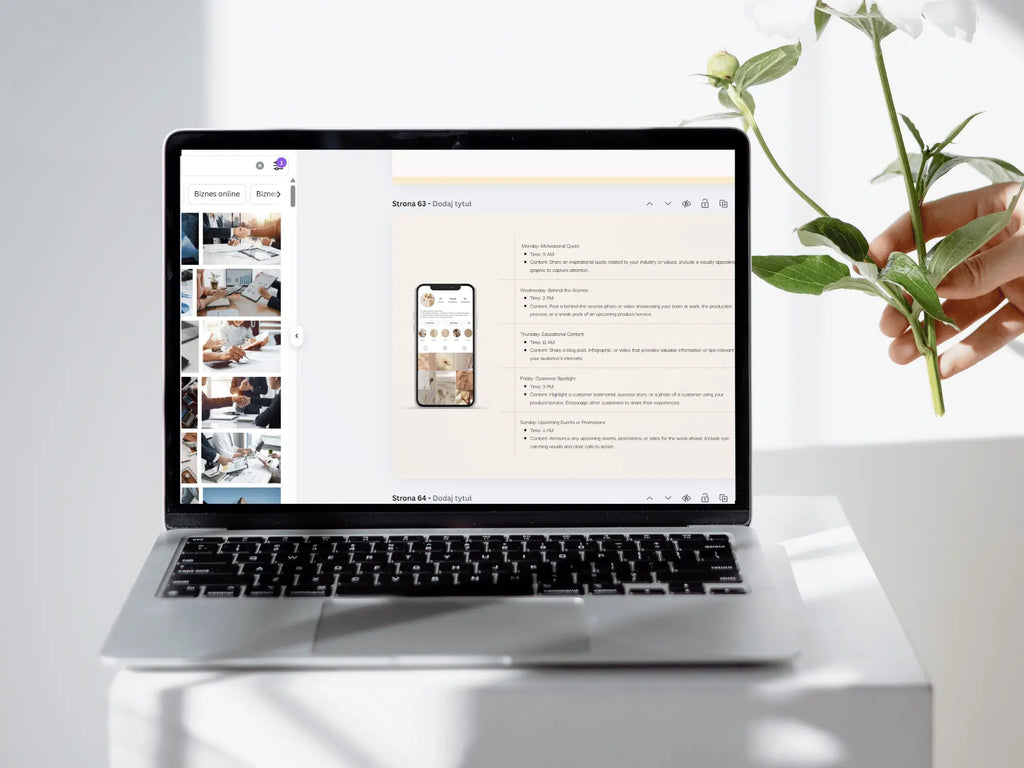 A silver laptop sits on a white pedestal, displaying a website mockup on its screen. A hand holding white flowers is visible on the right side of the frame against a bright, clean white background.