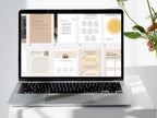 Laptop displaying a digital document on a white surface with a plant in the background