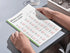Person holding a book with Turkish verb flashcards on a table
