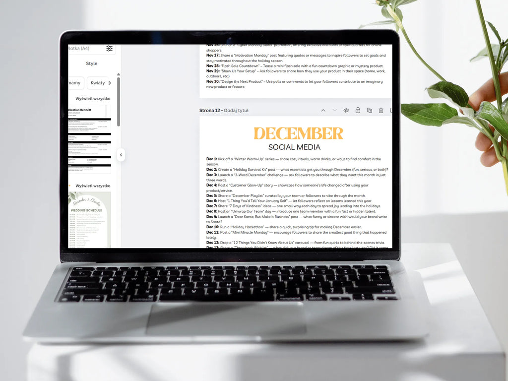 Laptop displaying a December social media planner on a white surface with a plant.