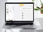 Laptop displaying a SMART Goals setting interface on a white desk with a plant.