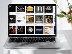 Laptop displaying a grid of various design templates on a white surface with a plant.