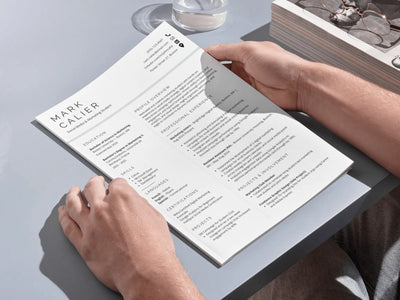 Person holding a menu with 'Mark Cullier' at a restaurant table.