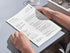 Person holding a menu with 'Mark Cullier' at a restaurant table.