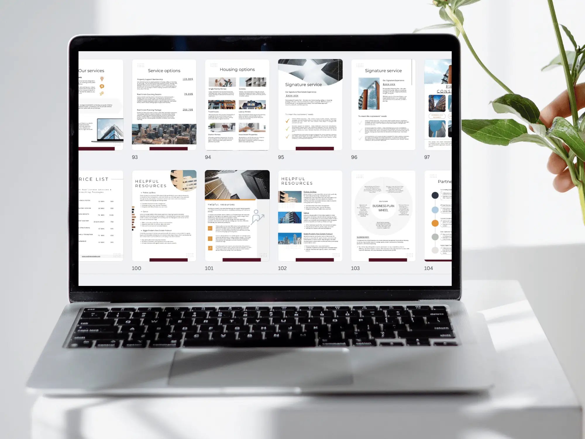 A laptop screen displaying a wide grid of numerous real estate template pages, ranging from service options to helpful resources and housing maps