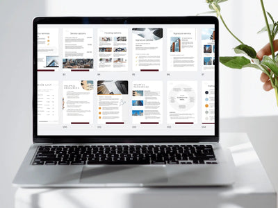 A laptop screen displaying a wide grid of numerous real estate template pages, ranging from service options to helpful resources and housing maps