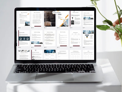 A laptop screen displaying a grid of many different business planning pages being edited in a design tool